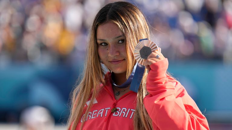 Bronze medalist Sky Brown of Great Britain poses for a photo with her medal after the women's skateboarding park final at the 2024 Summer Olympics, Tuesday, Aug. 6, 2024, in Paris, France. (AP Photo/Vadim Ghirda)