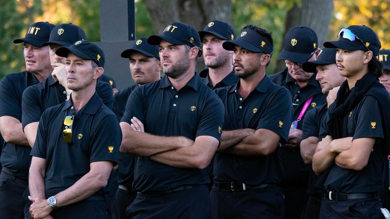 International team captain Mike Weir, left and his team look on prior to the trophy presentation at the Presidents Cup golf tournament at Royal Montreal Golf Club Sunday, Sept. 29, 2024 in Montreal. (Christinne Muschi/The Canadian Press via AP) 