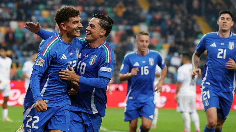 Giovanni di Lorenzo, left, celebrates after scoring for Italy