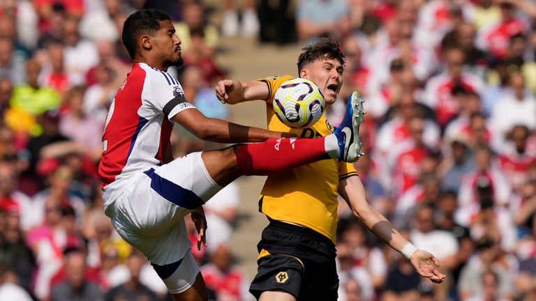 Arsenal's William Saliba challenges for the ball with Wolves' Jorgen Strand Larsen (AP Photo/Frank Augstein)