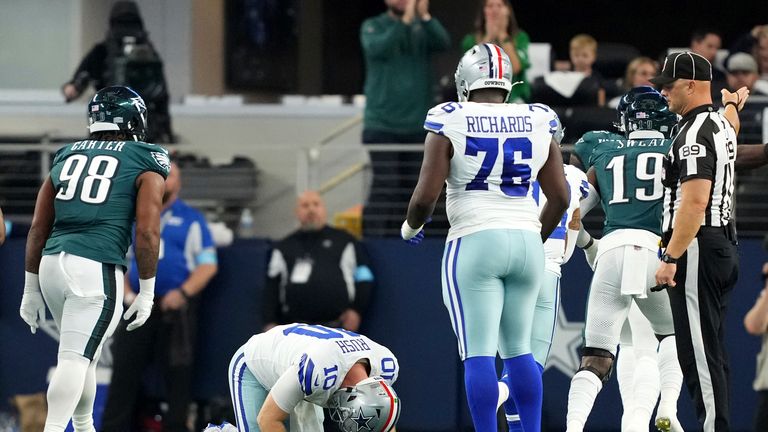 Dallas Cowboys quarterback Cooper Rush picks himself up off the turf after losing a fumble during the first half of a football game against the Philadelphia Eagles as offensive tackle Asim Richards (76) looks on Sunday, Nov. 10, 2024, in Arlington, Texas.