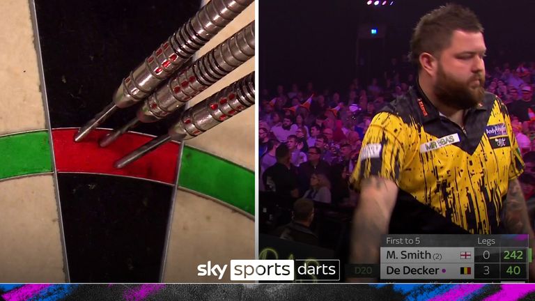 Michael Smith goes for and hits an incredible no-look 180 despite finding himself three legs down against Mike De Decker at the 2024 Grand Slam of Darts. 